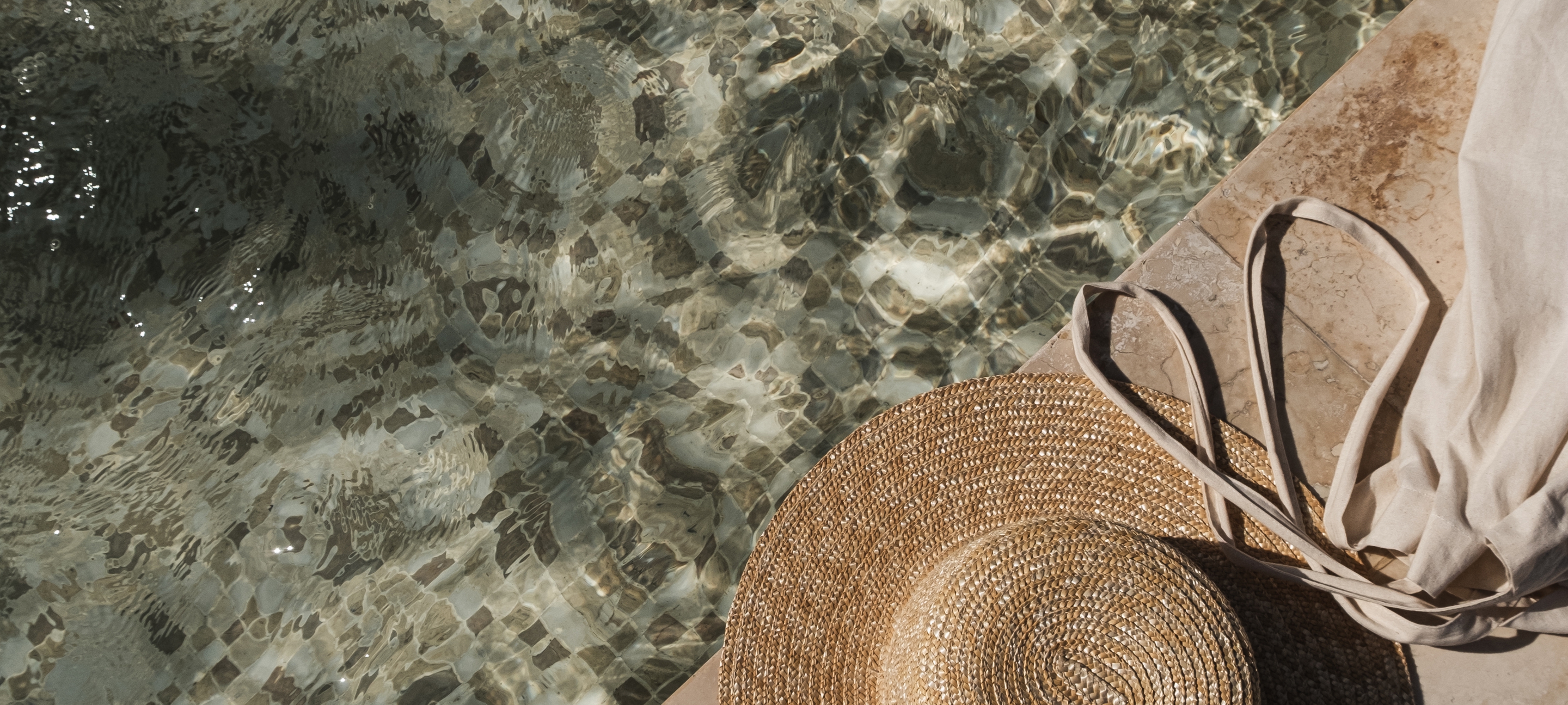 Flat,Lay,Of,Sunglasses,And,Straw,Hat,On,Marble,Swimming